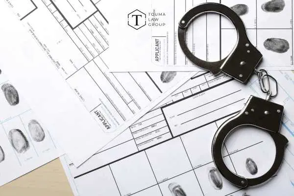 handcuffs and criminal records on a desk